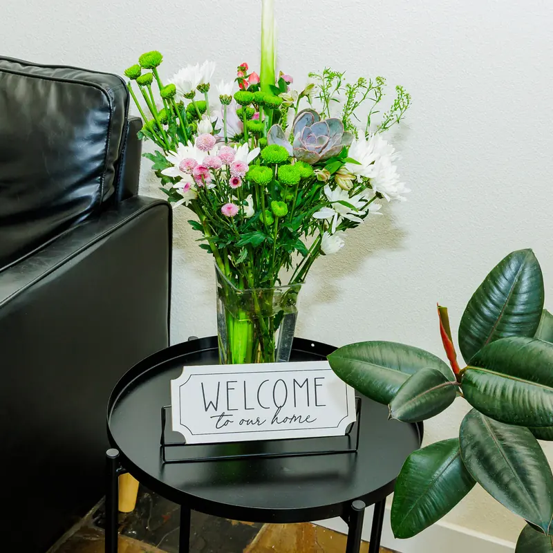 Welcome to our home sign with fresh flowers in the Fountain Assisted Living lobby, Mesa AZ